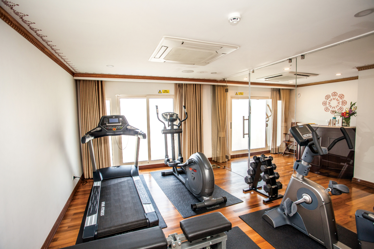 The gym is equipped with a treadmill, an exercise bike and an elliptical bike.