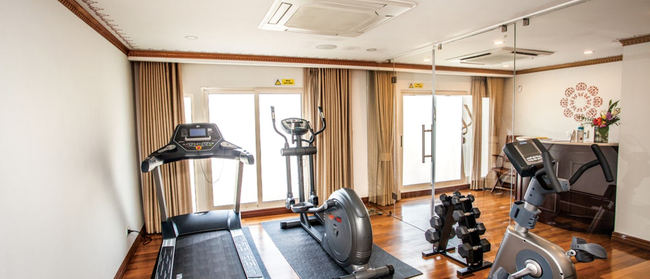 The gym is equipped with a treadmill, an exercise bike and an elliptical bike.
